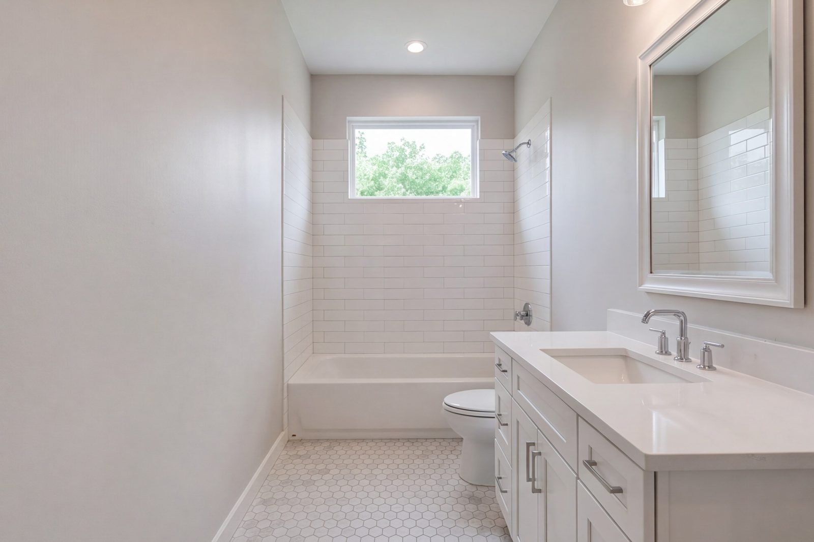 Small guest bathroom with a tub-shower, wide vanity and light tile